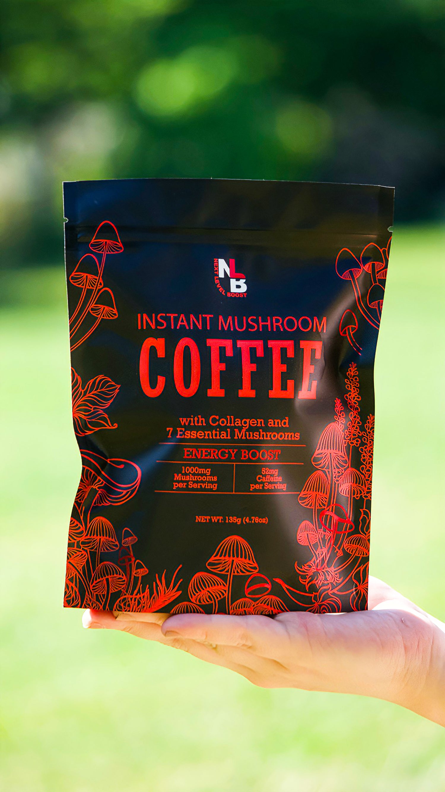 Hand holding a package of instant mushroom coffee with a blurred green background