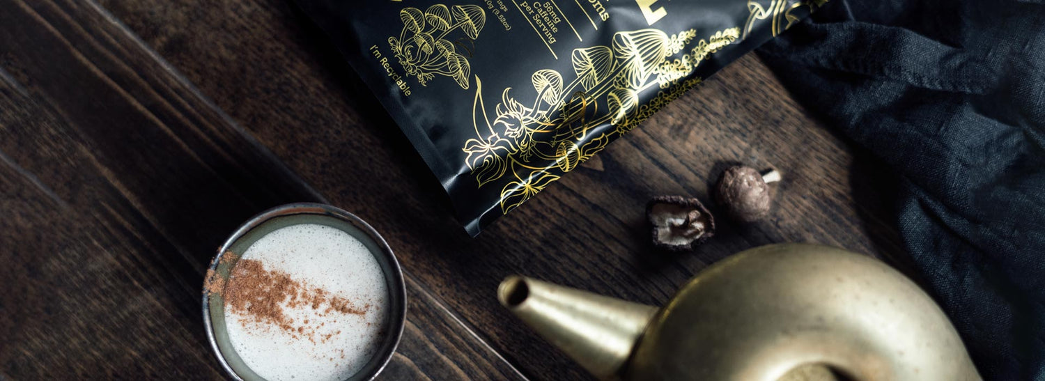 Kettle next to a cup of mushroom coffee and a package of Next Level Boost.