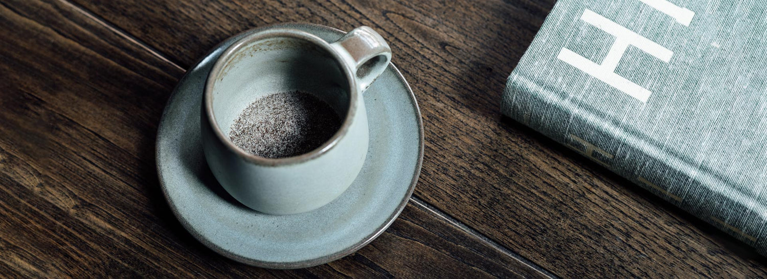 Cup containing powdered Next Level Boost mushroom coffee.