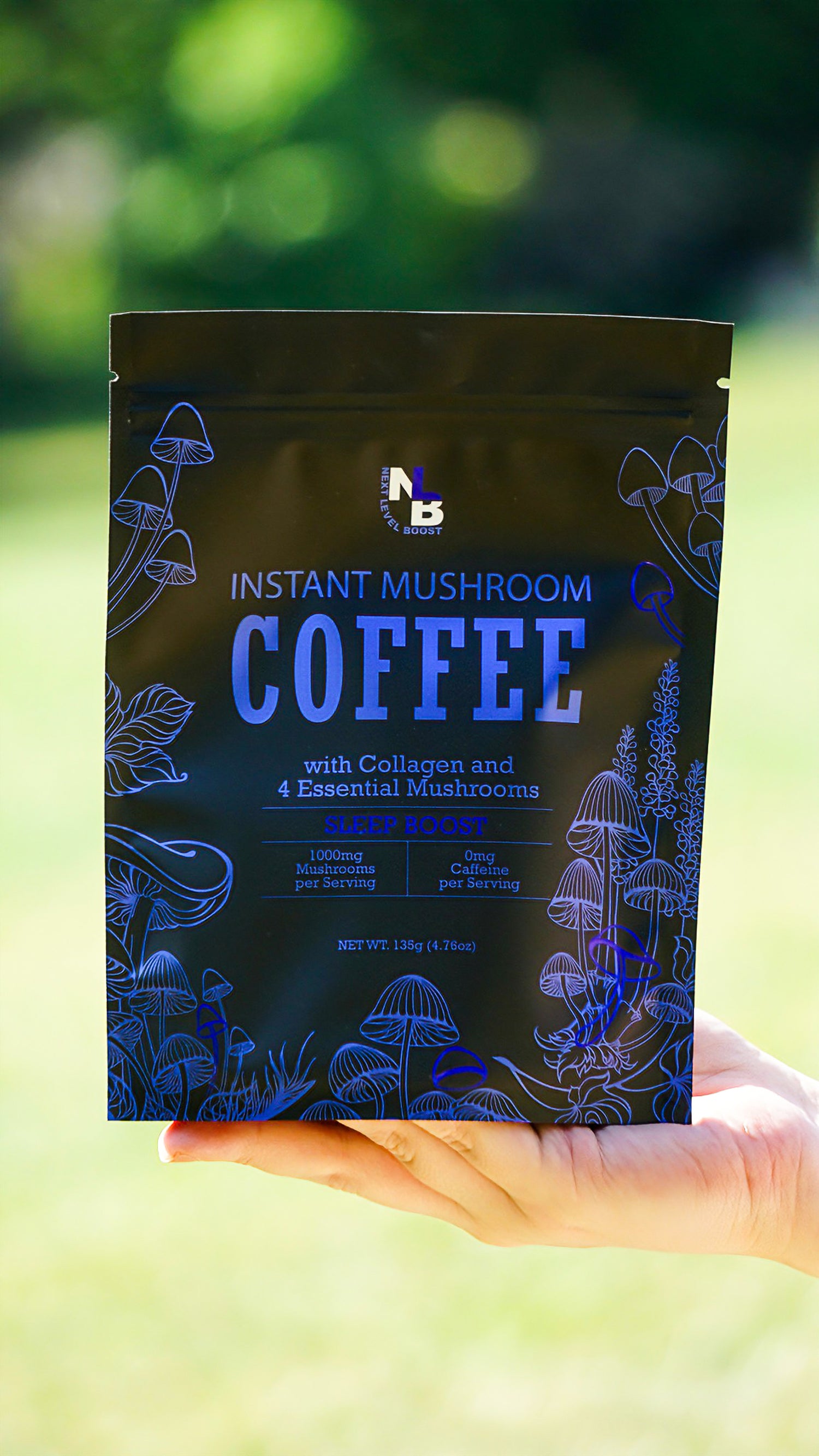 Hand holding a package of instant mushroom coffee with a blurred green background